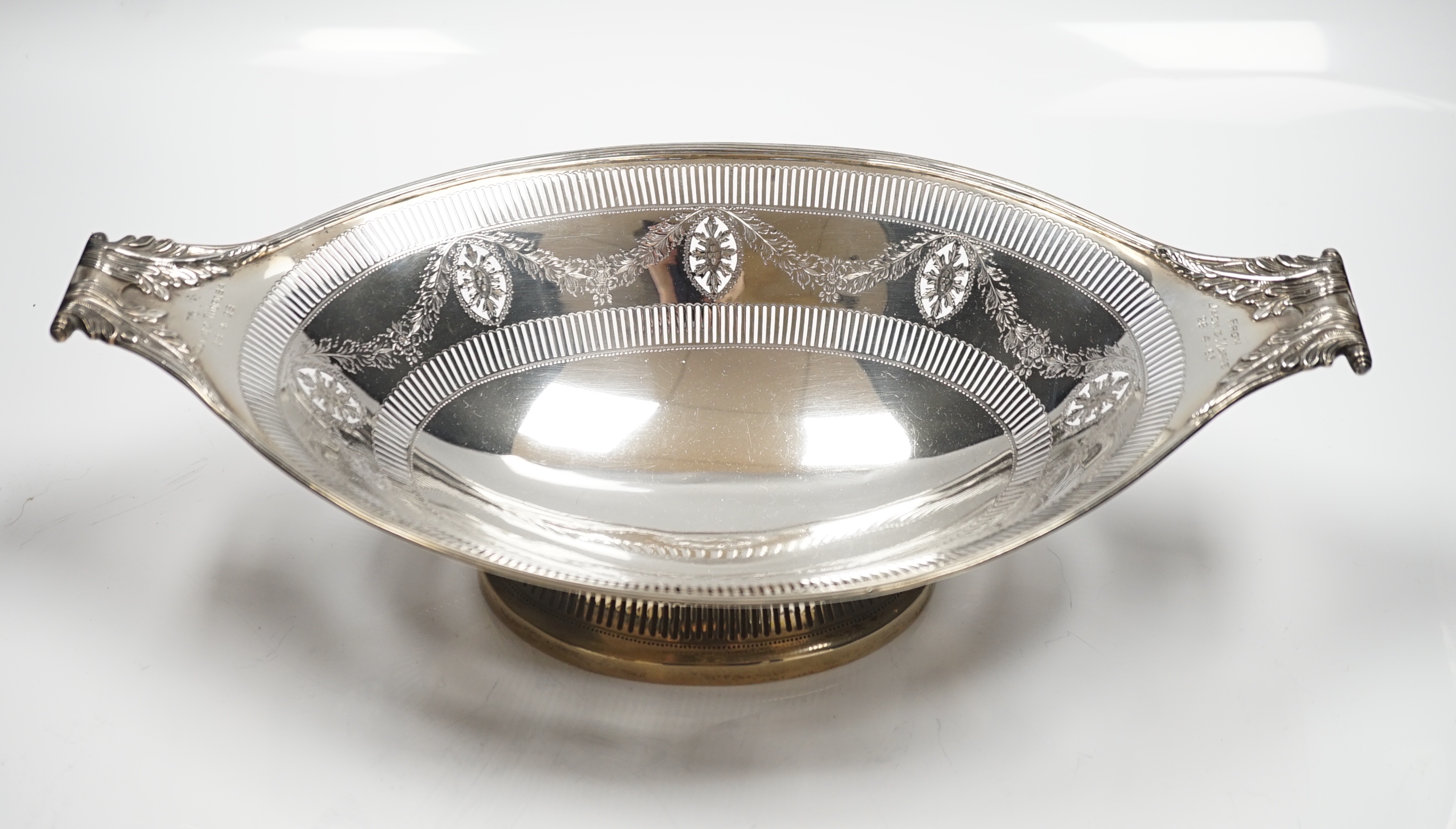 An Edwardian pierced silver two handled oval pedestal dish, with engraved inscriptions, Thomas Bradbury & Sons, Sheffield, 1907, 36.9cm, 18.8oz.